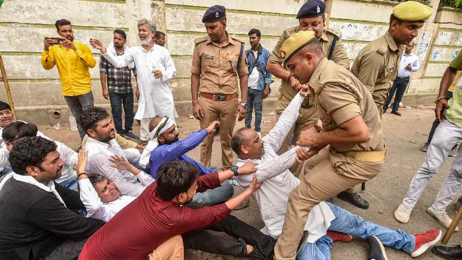 Police detain Uttar Pradesh Congress party workers during their Raj Bhawan march over Enforcement Directorates probe against party leader Rahul Gandhi in the National Herald case, in Lucknow