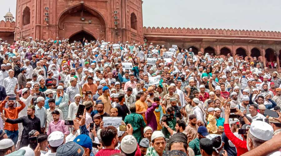 People belonging to Muslim community, holding placards, stage a protest over the controversial remarks by two now-suspended BJP leaders against Prophet Mohammad, after the Friday prayers at Jama Masjid, in New Delhi on Friday.