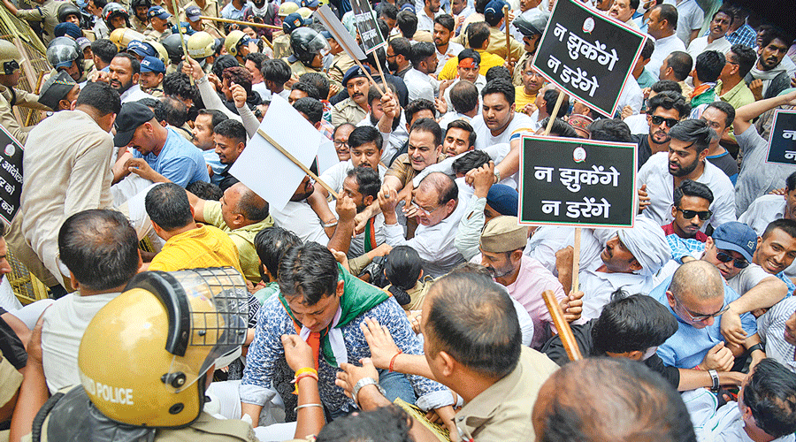 Police stop protesting Congress workers in Dehradun on Thursday.