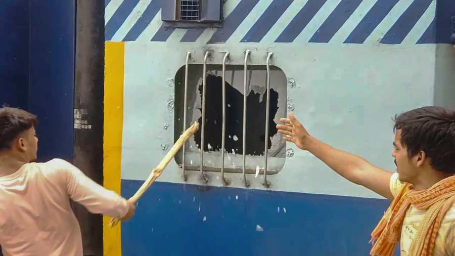 Youngsters vandalise a train in protest against the Agnipath scheme, at Bhabua Station in Kaimur district of Bihar