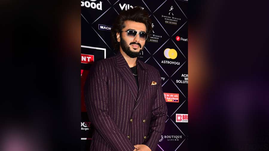 Arjun Kapoor went for a classic striped pant-suit look and topped it off with some stylish shades