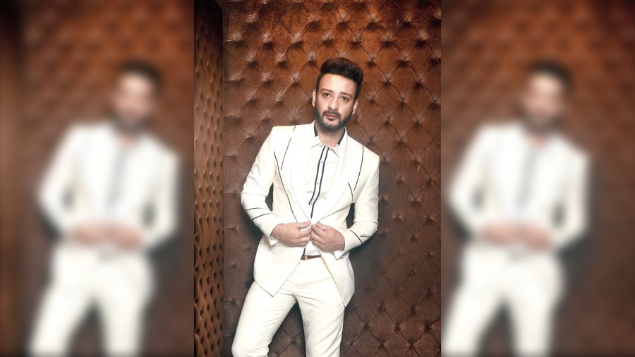 Shaheb posed for a dapper look in KJ by Kushal Jain’s satin-crepe jacket highlighted with metallic stripes. It is paired with a matching ivory shirt and trousers.