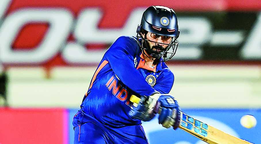India batsman Dinesh Karthik hits a reverse sweep during the fourth T20I against South Africa in Rajkot on Friday