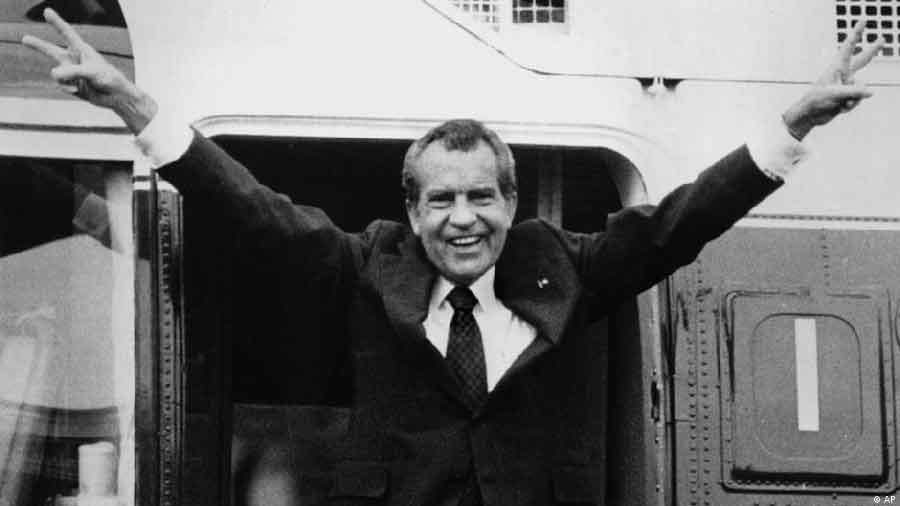 Richard Nixon flashes the victory sign as he boards a helicopter following his resignation