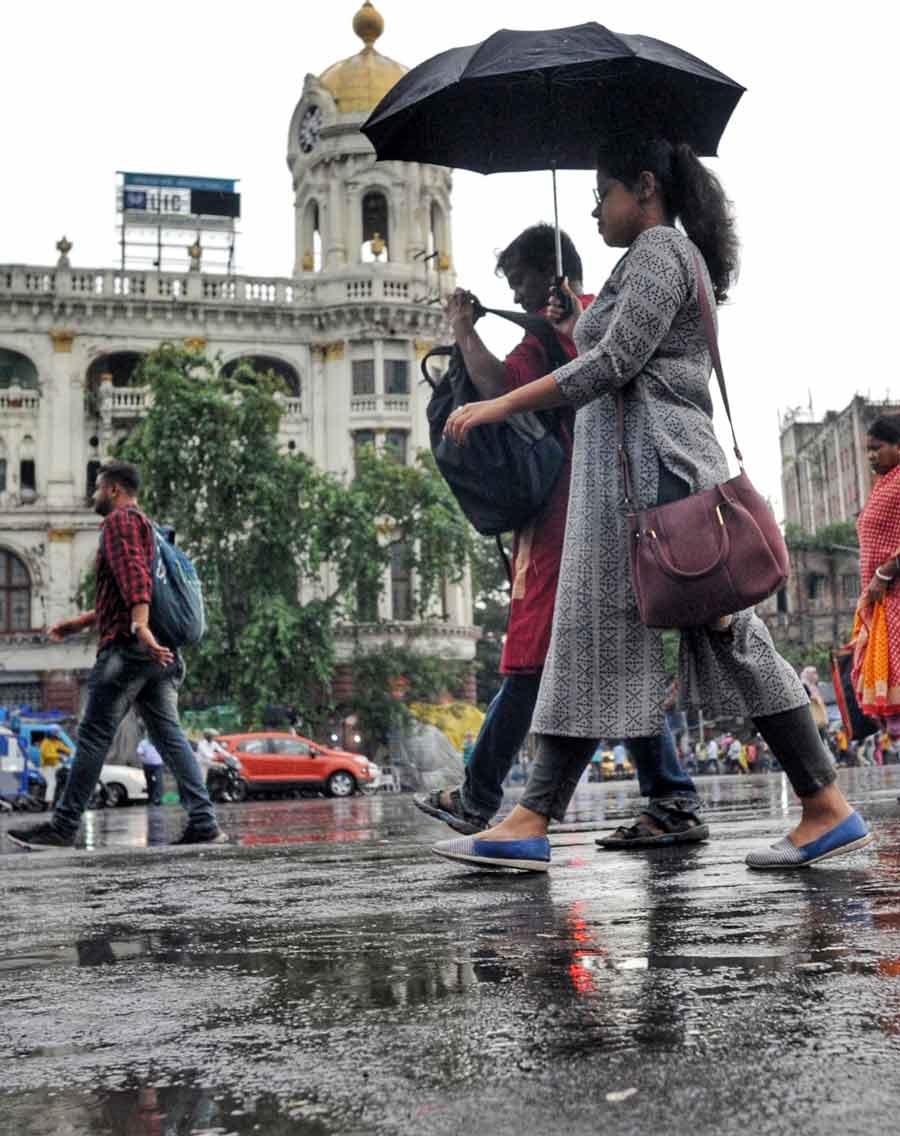 A woman with an umbrella as the city received its first monsoon showers of this season on Friday, June 17.
