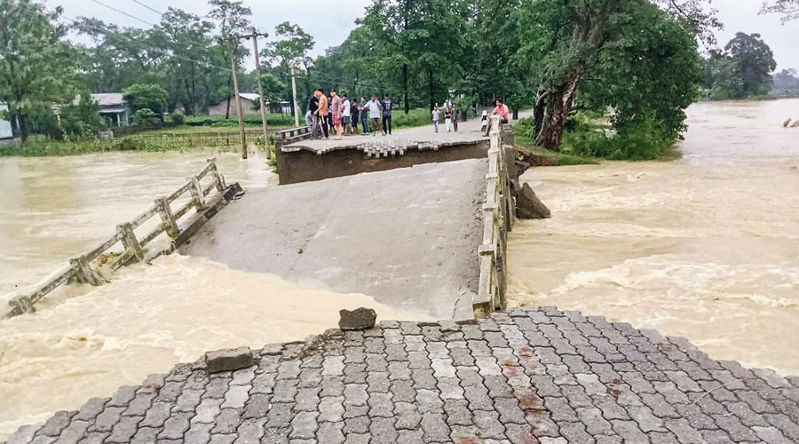A bridge damaged by the flood in Sonitpur district of Assam on Saturday.