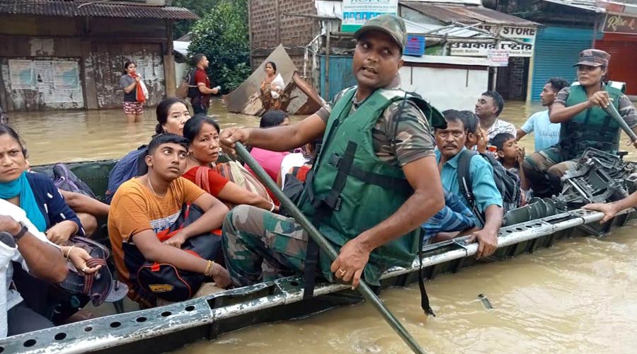 Security personnel rescue people from a flood-affected area in Silchar.