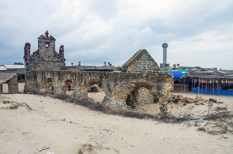 The ruins of the roofless church (in picture) are among the most visited sites. Apart from the front entrance, a few arches, and a portion of the altar, nothing remains of the old church. Makeshift shops on either side sell artefacts made of seashells 