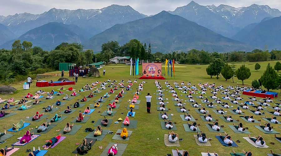 Army personnel and their family members attend a mega yoga session on International Day of Yoga, in Yol near Dharamshala