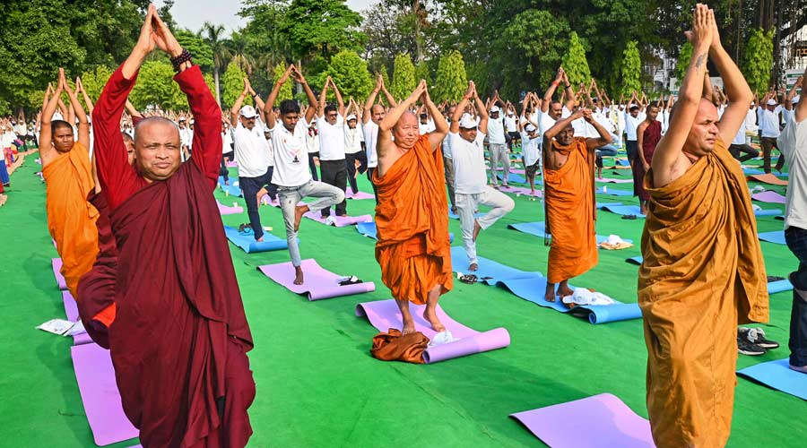 Buddhist monks along with locals perform yoga during a yoga session on the occasion of the 8th International Day of Yoga, at Mahabodhi temple in Bodh Gaya