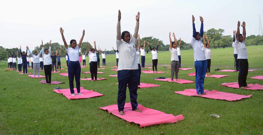Members of the National Cadet Corps practise yoga to mark International Yoga Day on the Maidan on Tuesday.