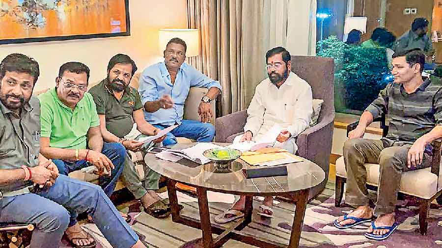 Rebel Shiv Sena leader Eknath Shinde (second from right) with other MLAs at a hotel in Guwahati on Wednesday