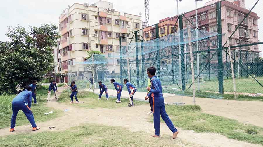 With the fenced ground under lock and key, the cricket coaching camp in CB Block being held on a rough patch just behind the fencing on Sunday. 