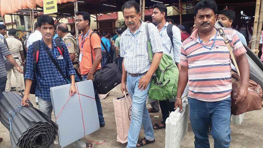 Polling personnel head for booths for the three-tier panchayat elections to the Siliguri Mahakuma Parishad on Saturday.  