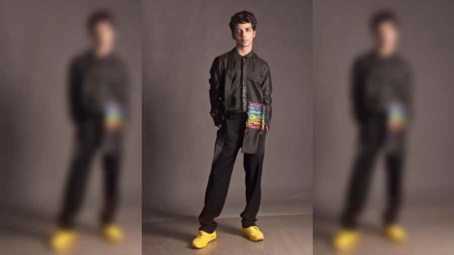 Niranjan M sports a black silk Chanderi asymmetric overlay shirt with an inside-out pocket with rainbow-dyed shibori cord detail and a hanging collar teamed with black straight-fit trousers. “This is my first editorial and fashion shoot. I am a bit nervous, but everyone else is super cool, putting me at ease. What Rahul has given me is more in sync with my style,” says Niranjan.