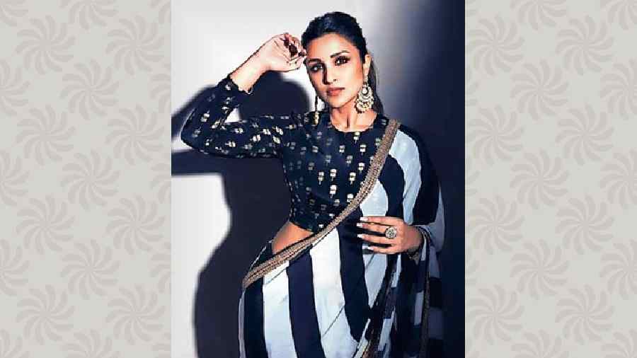 Black-and-white dominates Parineeti Chopra’s wardrobe and her Instagram account is proof of that. From diving suits and ultra glam looks to casuals, she dons this classic colour combo quite often. We loved how gorgeous she looked in the minimal yet glam Masaba black-n-white striped sari.