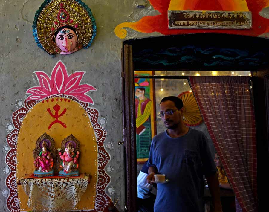 Banibrata serves a cup of coffee to a guest.