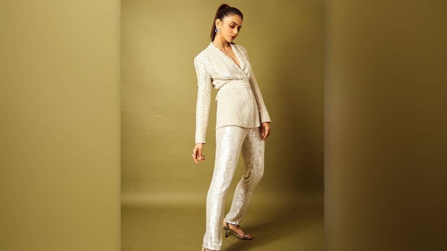 In a Rohit Gandhi-Rahul Khanna bling power suit teamed with stilettos and a sleek ponytail, Rakul shares notes on partywear done right, but with a twist.