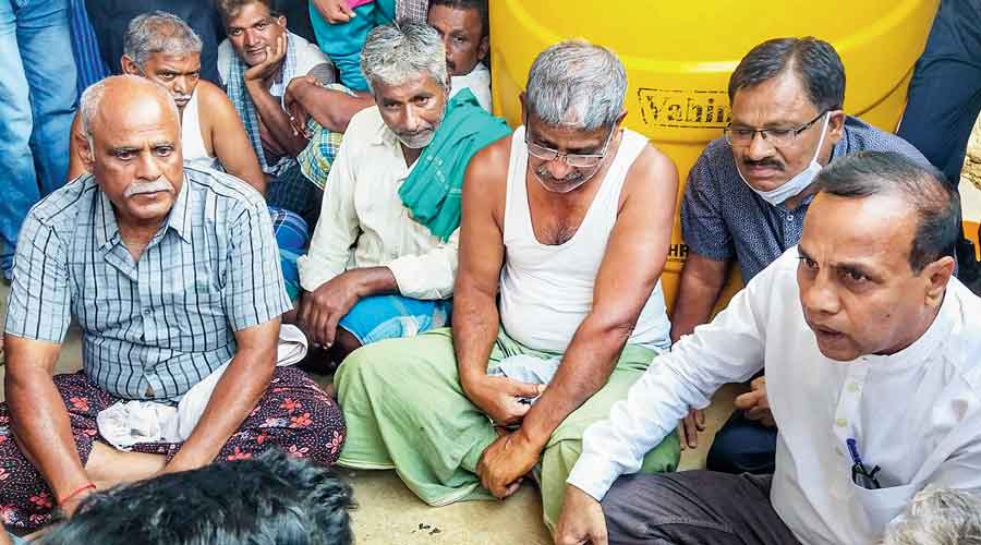 Relatives and friends gather at the residence of Naveen Shekharappa Gyanagoudar at Chalageri village in  Haveri, Karnataka, on Tuesday.