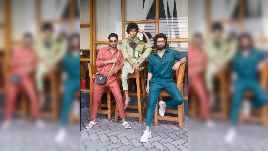 (L-R) On Kutubuddin, a peach khadi linen trouser and shirt paired with a conductor bag. On Udit, a pista green asymmetric shirt with box pleats on the sleeves, paired with a scarf and cropped trousers. Iqbal dressed simple in a dark green shirt and trousers. 