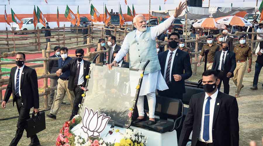 Prime Minister Narendra Modi waves to supporters as he arrives at the  “Booth Vijay Sammelan” in Varanasi on Sunday. 
