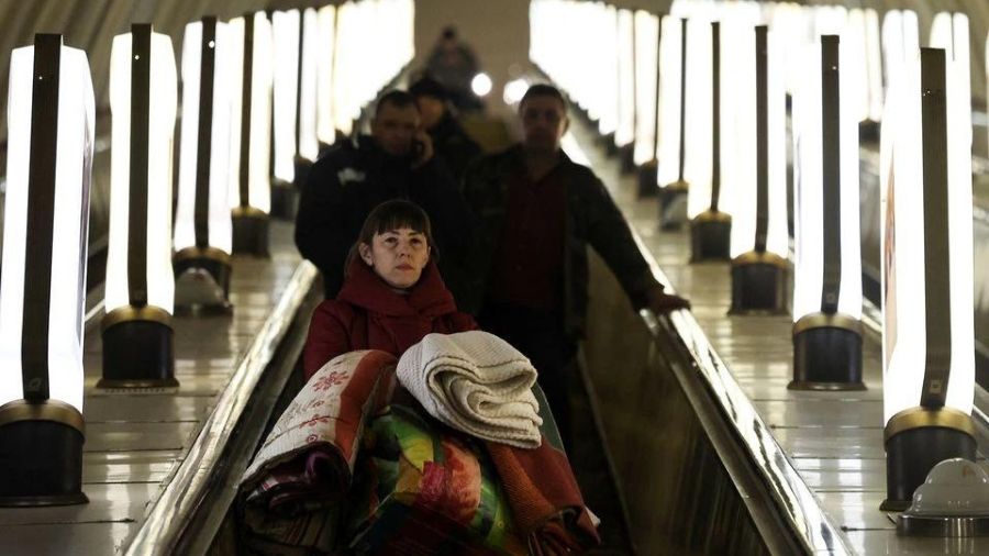  A local resident arrives at a shelter inside of an underground metro station as Russia's invasion of Ukraine continues, in Kyiv.