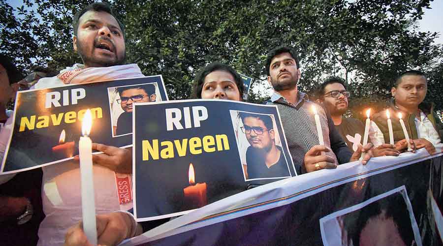 Youth Congress members in Patna hold placards and light candles on Wednesday to pay homage to Naveen Shekharappa, a medical student killed in Russian shelling in Kharkiv. 