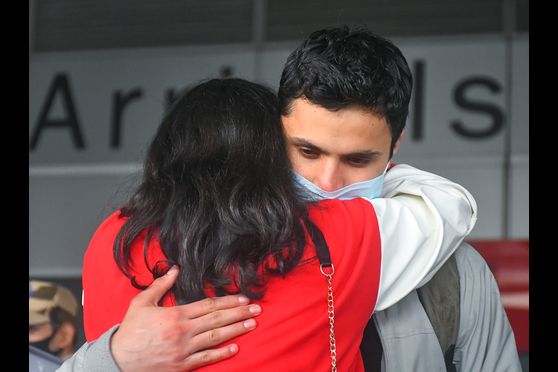 Relatives greet Indian students, evacuated from war-torn Ukraine, upon their arrival at the Indira Gandhi International Airport in New Delhi on March 4.