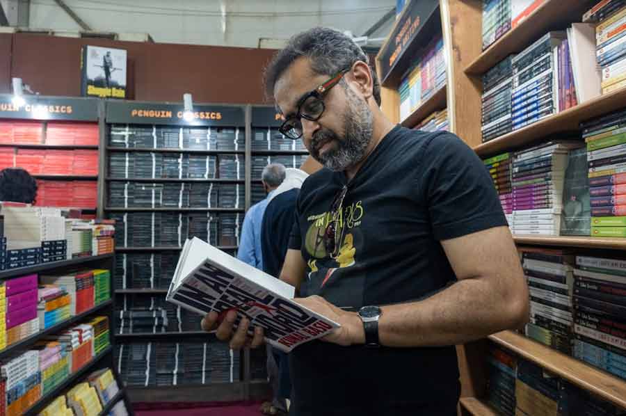 Ghosh leafs through Kunal Basu’s ‘An Ideal World’ at The Oxford Bookstore stall in Hall 2. 'Is this the latest book by him?' Ghosh enquires before adding that Basu ‘is someone I really admire. I wish to have a proper conversation with him sometime soon’ 