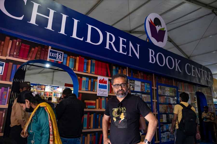 Ghosh outside Children Book Centre, one of three stalls in Hall 2 where his book on Soumitra Chatterjee is available 