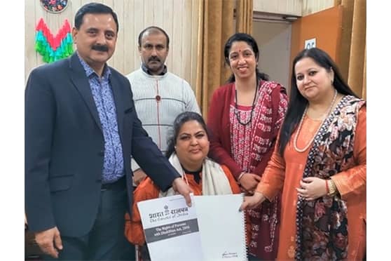 Sandhya Dhar (sitting), president of the NGO Jiger, also presented an enlarged font version of the RPwD Act and allied literature to JU.