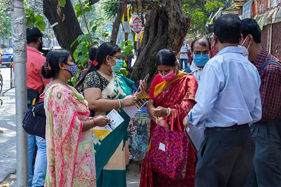 Guardians of Madhyamik candidates wait outside Bethune Collegiate School, Kolkata. 