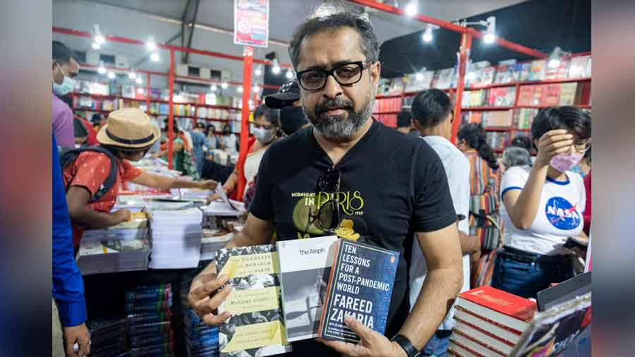 Ghosh poses with the three titles he bought from the Oxford Bookstore stall 