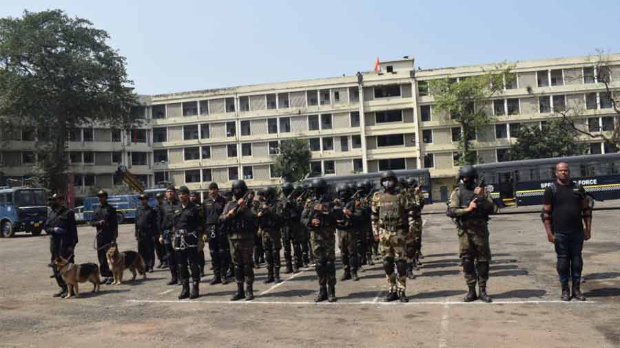 Kolkata police personnel stand alert at a parade at the police training school in south Kolkata on Monday
