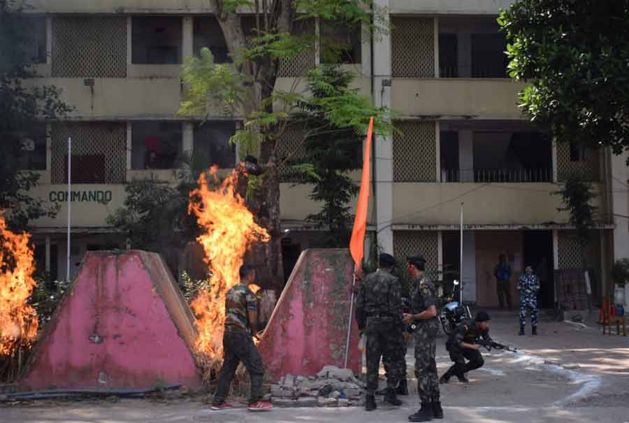 Cops jump across a fire during one of the drills on Monday