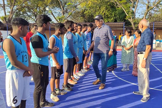 Ashok Kumar, former executive member of the Basketball Federation of India, meets the players after inaugurating the new basketball court at DBMS Kadma High School, Jamshedpur.