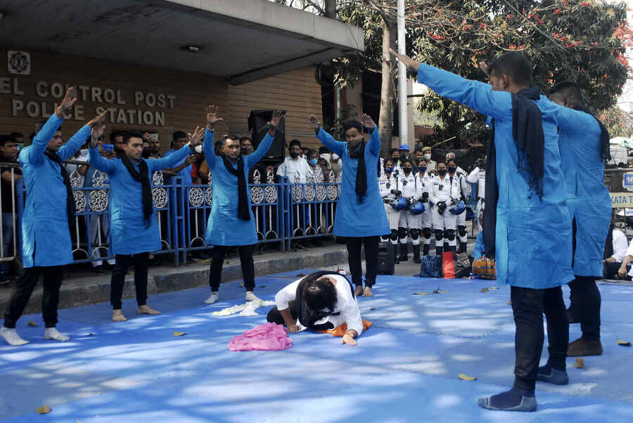 Artistes perform in a street play organised by Kolkata police near Esplanade on Tuesday