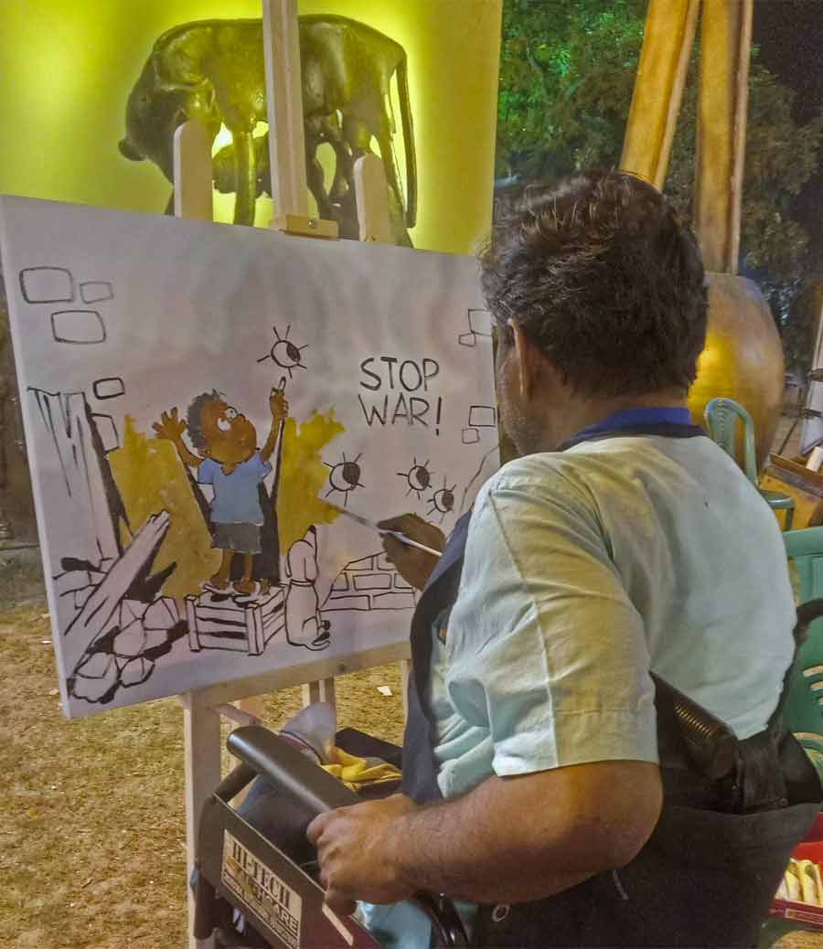 A painter draws an anti-war illustration on Wednesday at Rabindra Sadan 