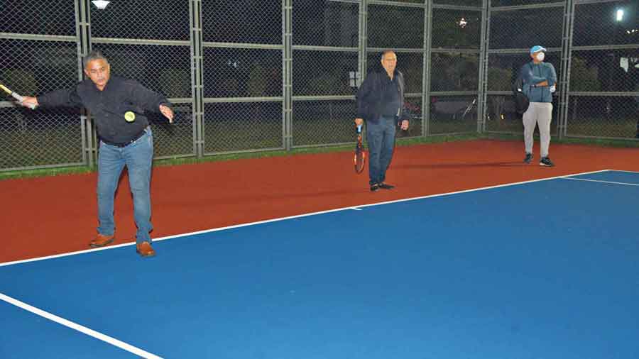Raj Kanojia, a Rosedale Garden resident, set to hit a ball alongside Jaideep Mukerjea on the new tennis court