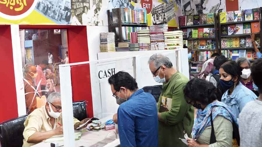 Customers at the cash counter of the Dey’s Publishing stall at the book fair on Saturday. 
