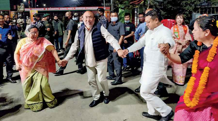 N Biren Singh and Manipur BJP chief A Sharda Devi dance in celebration after the party’s victory in the Assembly  elections, in Imphal, on Thursday. 