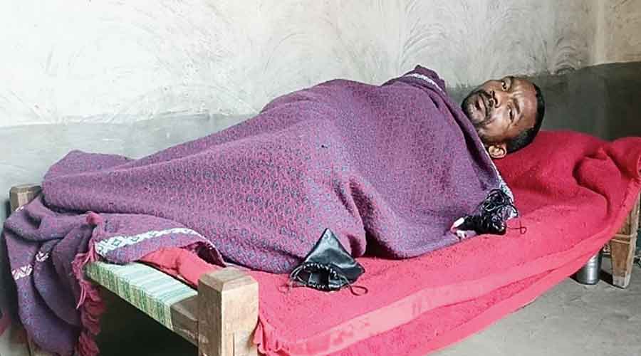 Anil Kumar Singh lies at his house in Latehar  on Thursday.