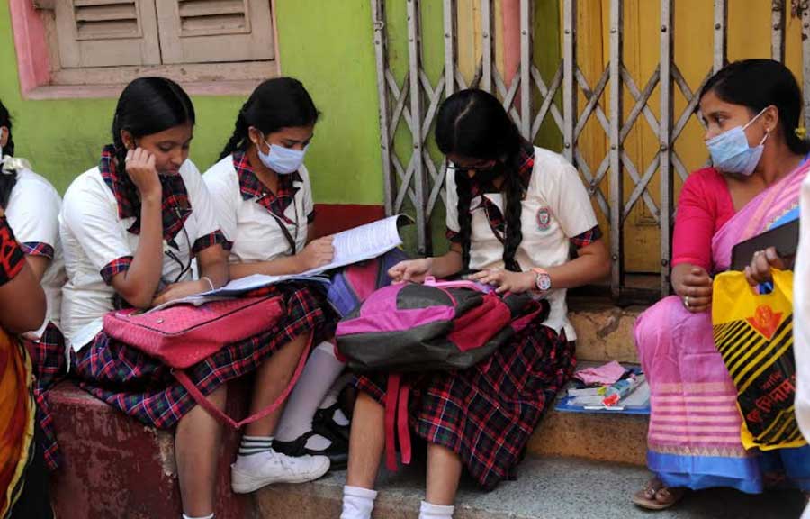 LAST-MINUTE REVISION: Students pore over their notes before the exam at a school in north Kolkata on Monday, March 7. The state board secondary exam began on March 7 with the first language paper. It will continue till March 16