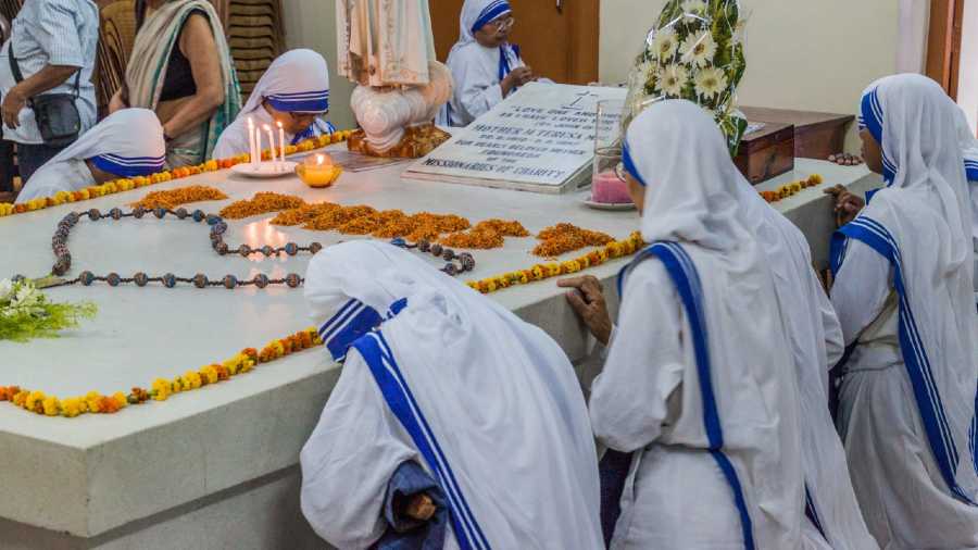 Sisters of The Missionaries of Charity pray at Mother Teresa’s tomb inside Mother’s House in Kolkata 