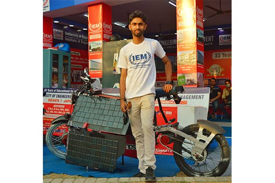 Souhridya Bhattacharjee with the solar motorbike.  