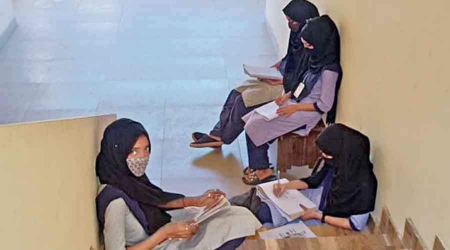 The four hijab-clad girls, who were denied entry into classes in the Government Pre-University College in Udupi, taking notes from a staircase of the college building.
