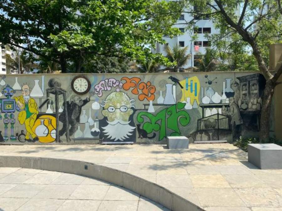 Opposite the lab is a wall adorned with graffiti that depicts aspects of the character most fundamental to his existence. We see multiple iterations of the physicist immersed in his experiments 