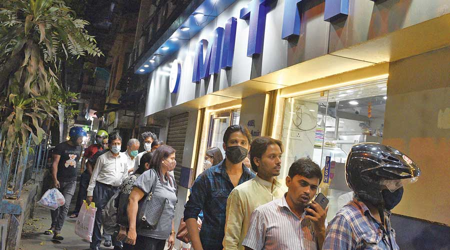 Customers queue up outside Mithai in Beckbagan on Thursday evening