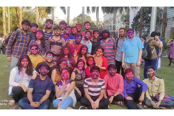 Undergraduate students from the department of Statistics pose for a group photo after playing with colors.