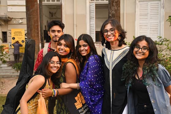 Students of Presidency University pose for a group photograph during the Holi celebrations on campus.